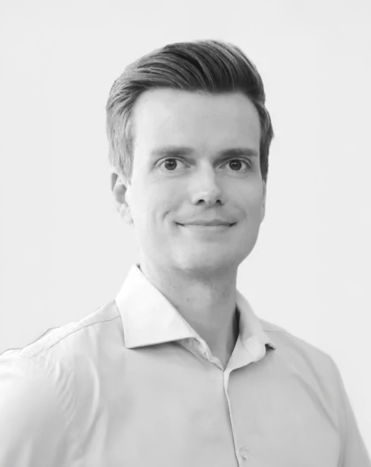 Black and white portrait of Julian Senoner wearing a light collared shirt