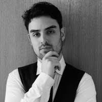 Black and white portrait of Arman Pour Tak Dost with hand on chin