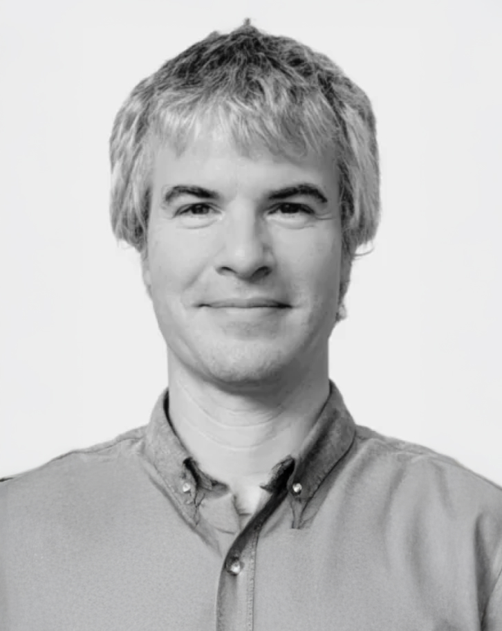 Black and white portrait of Roland Philippsen wearing a button-down shirt