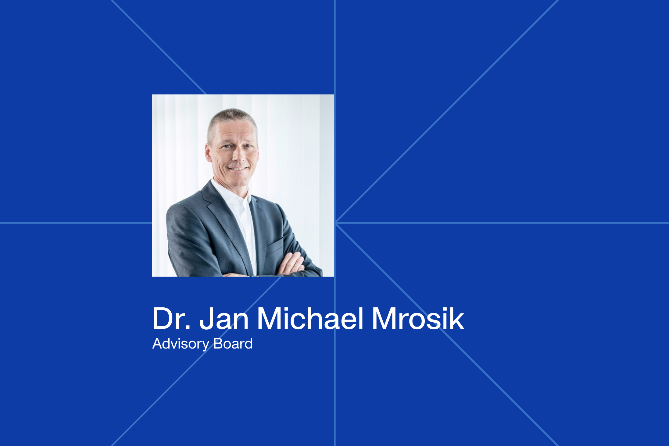 Portrait of Dr. Jan Michael Mrosik, Advisory Board member, on a blue background