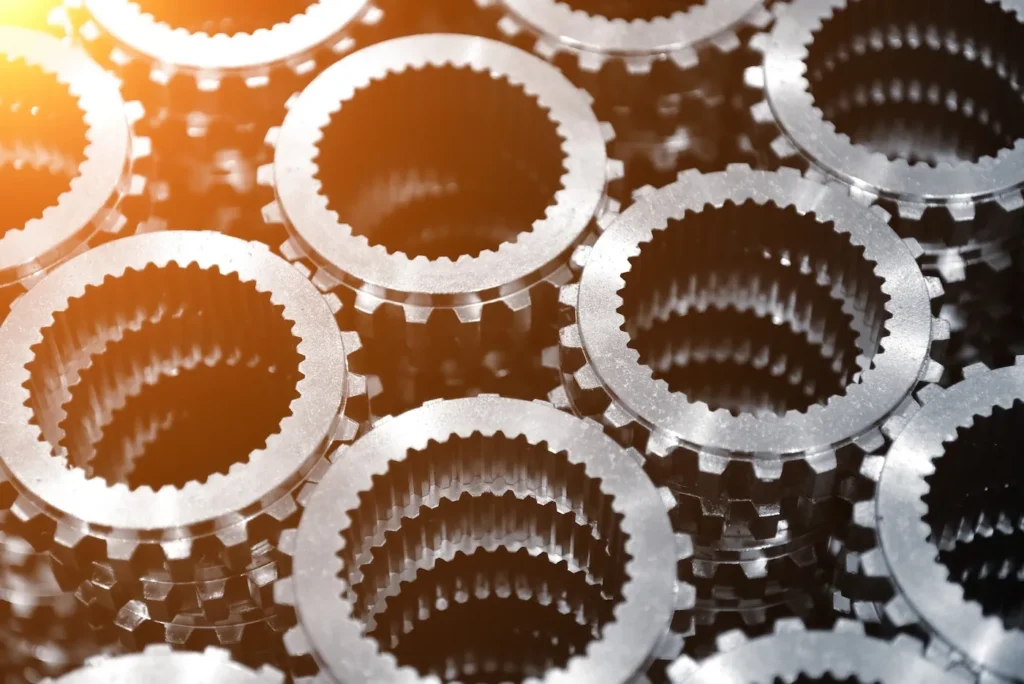 A closeup photo of gears with a shiny metal surface finish 