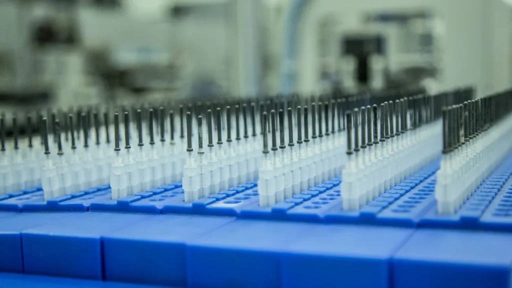 A closeup view of plastic parts and assemblies in a medical device production line 